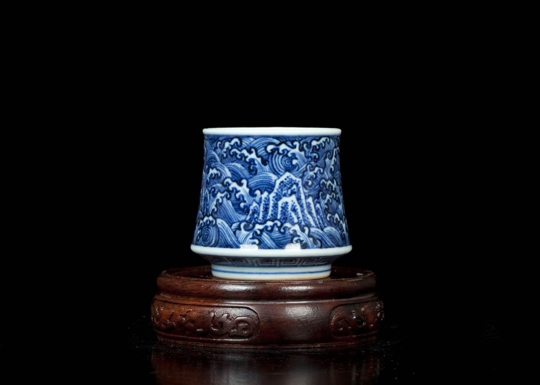 Blue and white porcelain wine-tasting glass with overlapping peaks