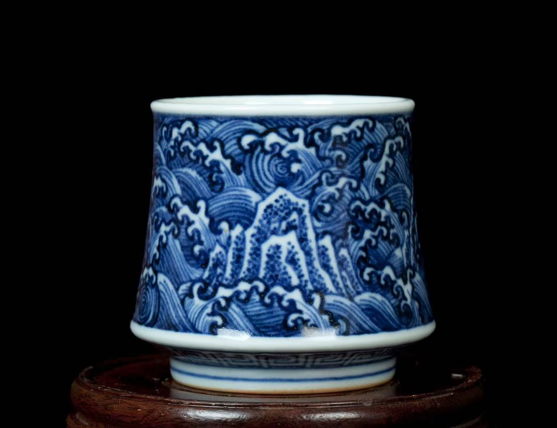 Blue and white porcelain wine-tasting glass with overlapping peaks